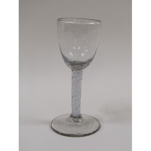 1873 - A mid 18c wine glass with an ogee bowl and a double series opaque twist stem on a slightly dome foot... 