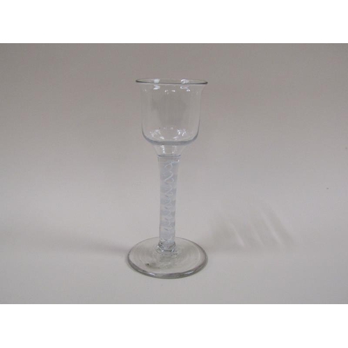 1874 - A mid 18c wine glass with a round funnel bowl on a twelve ply spiral with a pair of spirals tapes on... 