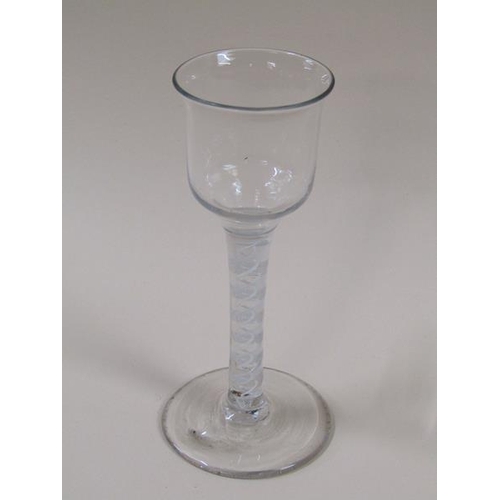 1874 - A mid 18c wine glass with a round funnel bowl on a twelve ply spiral with a pair of spirals tapes on... 