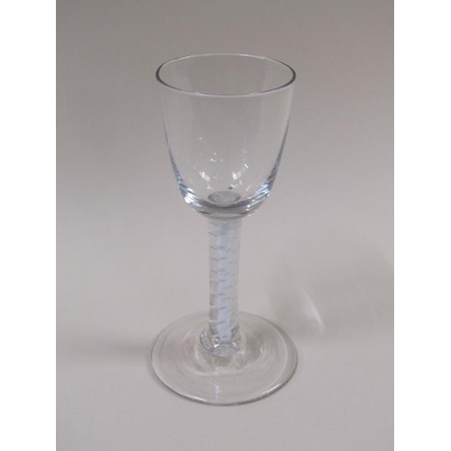 1875 - A mid 18c wine glass with a round funnel bowl on a double series opaque twist outside a single tape ... 