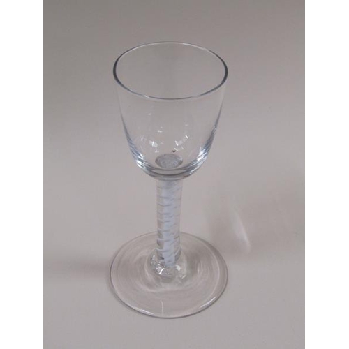 1875 - A mid 18c wine glass with a round funnel bowl on a double series opaque twist outside a single tape ... 