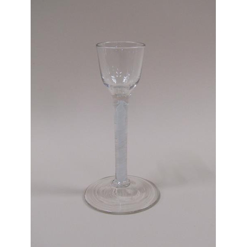 1876 - A mid 18c cordial glass with a round funnel bowl on a fifteen ply spiral band outside a spiral tape ... 