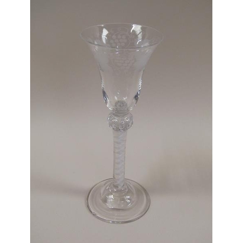 1879 - A pair of 18c wine glasses, the bell shaped bowls engraved with borders of fruiting vine.  The stems... 