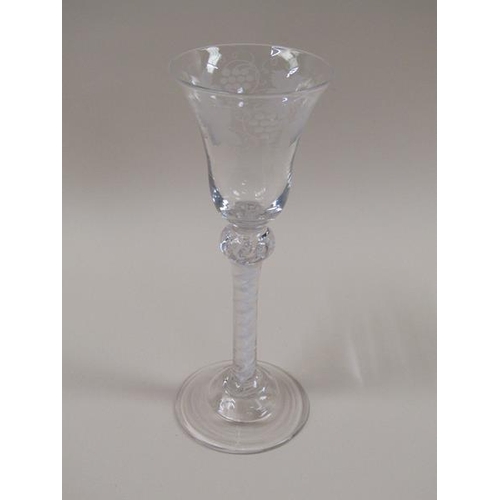 1879 - A pair of 18c wine glasses, the bell shaped bowls engraved with borders of fruiting vine.  The stems... 