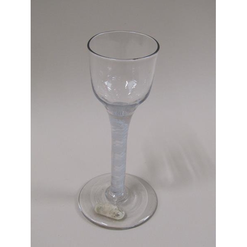 1880 - A mid 18c wine glass with a round funnel bowl on a twelve ply spiral band outside a pair of spiral t... 