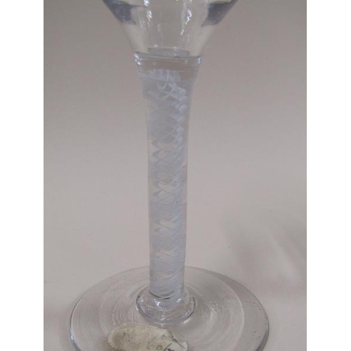 1880 - A mid 18c wine glass with a round funnel bowl on a twelve ply spiral band outside a pair of spiral t... 