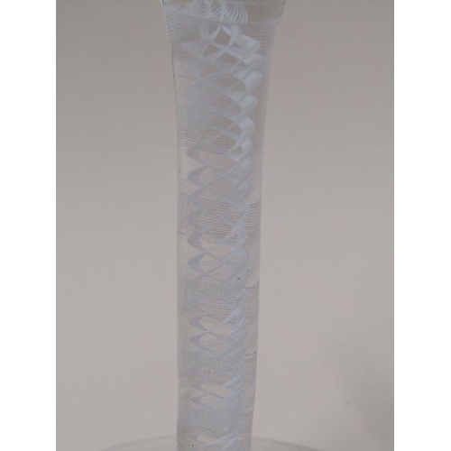 1880 - A mid 18c wine glass with a round funnel bowl on a twelve ply spiral band outside a pair of spiral t... 