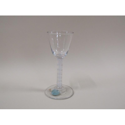 1882 - A mid 18c wine glass with a round funnel bowl on a double series opaque twist stem with a spiral tap... 