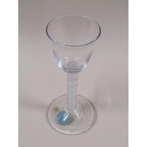 1882 - A mid 18c wine glass with a round funnel bowl on a double series opaque twist stem with a spiral tap... 