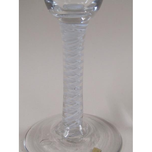 1885 - An 18c wine glass with a round funnel bowl and a double series opaque white twist stem on a domed ci... 