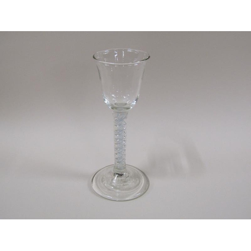 1888 - An 18c wine glass with a round funnel bowl on an white opaque and clear double twist stem on a circu... 