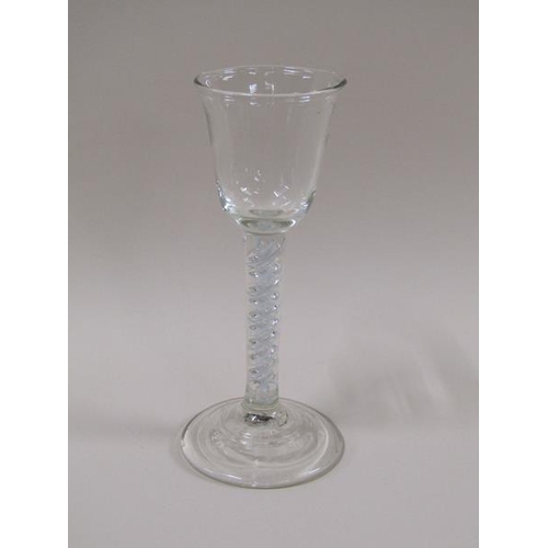 1888 - An 18c wine glass with a round funnel bowl on an white opaque and clear double twist stem on a circu... 