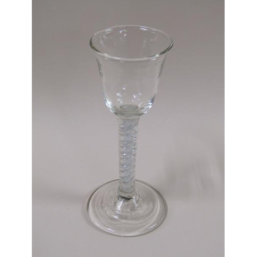 1888 - An 18c wine glass with a round funnel bowl on an white opaque and clear double twist stem on a circu... 