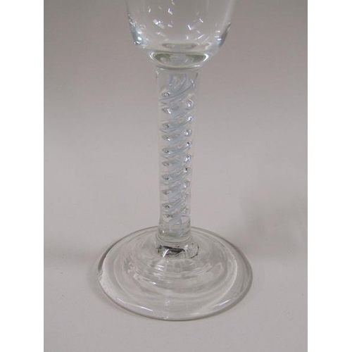 1888 - An 18c wine glass with a round funnel bowl on an white opaque and clear double twist stem on a circu... 