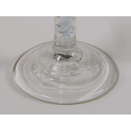 1888 - An 18c wine glass with a round funnel bowl on an white opaque and clear double twist stem on a circu... 