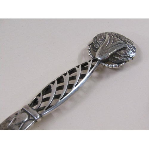 1733 - An early 20c Georg Jensen silver spoon with decorative handle and terminal, c.1925, 2.3ozt, 18.5cm l... 