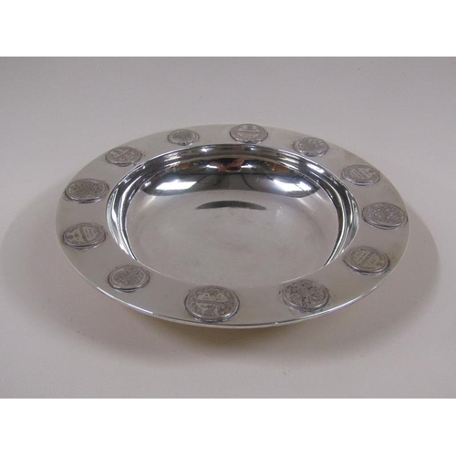 1740 - An early 20c silver dish with coin border decoration, London 1909, 10ozt, 18.5cm diam.