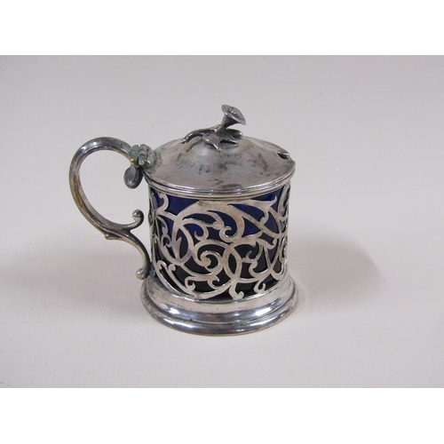 1741 - A William IV silver mustard pot with a pierced frame, double scroll handle, hinge cover and having a... 