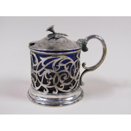 1741 - A William IV silver mustard pot with a pierced frame, double scroll handle, hinge cover and having a... 