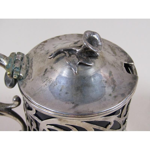 1741 - A William IV silver mustard pot with a pierced frame, double scroll handle, hinge cover and having a... 