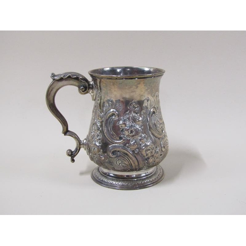 1743 - A George II silver half pint baluster tankard with later leaf, scroll and flower embossing, with dou... 