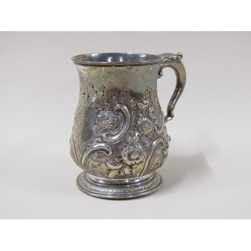 1743 - A George II silver half pint baluster tankard with later leaf, scroll and flower embossing, with dou... 