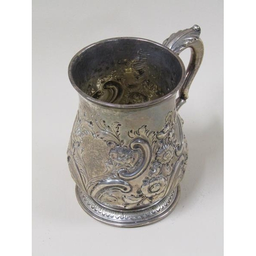 1743 - A George II silver half pint baluster tankard with later leaf, scroll and flower embossing, with dou... 