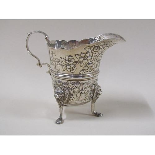 1745 - An Irish silver cream jug with wide pouring spout, later embossed and chased floral decoration, the ... 