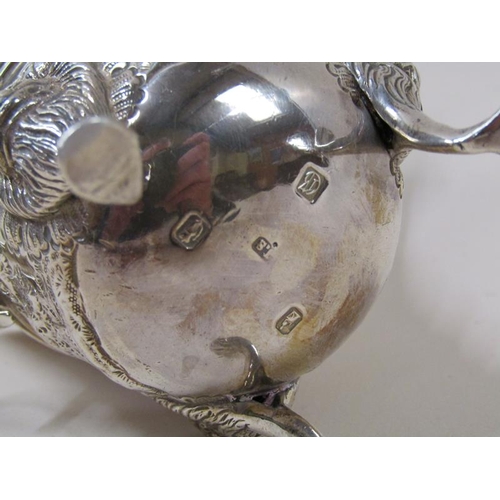 1745 - An Irish silver cream jug with wide pouring spout, later embossed and chased floral decoration, the ... 