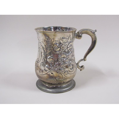 1747 - A George III baluster tankard with later embossed and chased floral and scroll decoration, with doub... 