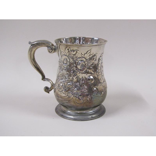 1747 - A George III baluster tankard with later embossed and chased floral and scroll decoration, with doub... 