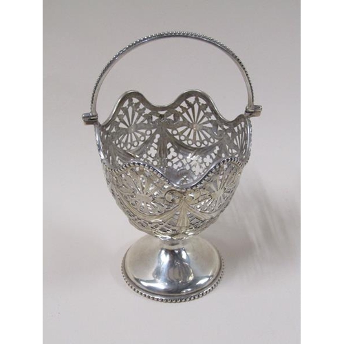 1750 - A late Victorian silver bonbon basket with a pierced swag decorated bowl, having a beaded swing hand... 