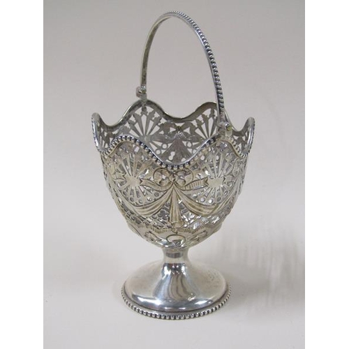 1750 - A late Victorian silver bonbon basket with a pierced swag decorated bowl, having a beaded swing hand... 