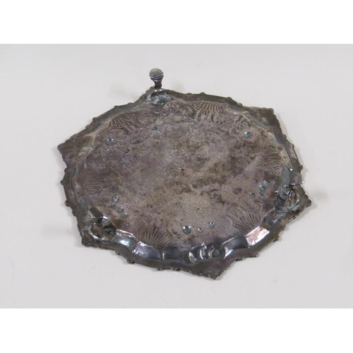 1755 - A late 18c salver of circular form on three legs, having a raised shaped border, assay marks rubbed,... 