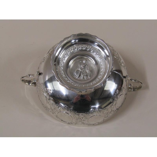 1756 - A Continental silver two handled bowl on stand with coin border decoration, heart terminals to the h... 