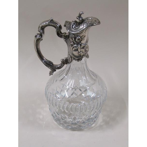 1807 - A late Victorian cut glass baluster claret jug with silver plated mount, decorated with embossed scr... 