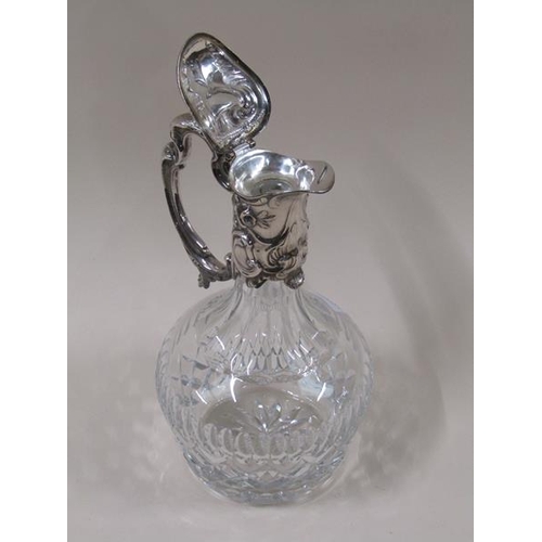 1807 - A late Victorian cut glass baluster claret jug with silver plated mount, decorated with embossed scr... 