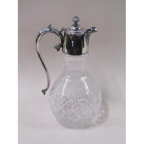 1808 - An Edwardian cut glass baluster claret jug with silver plated mount and having scrolling handle, 31c... 