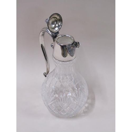 1808 - An Edwardian cut glass baluster claret jug with silver plated mount and having scrolling handle, 31c... 