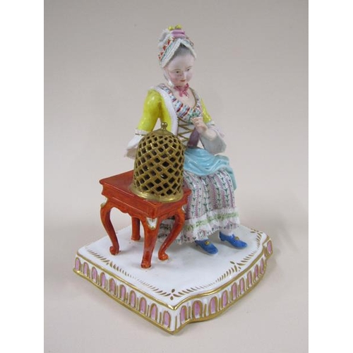 1967 - A pair of Meissen porcelain figure groups - girl seated feeding bird in cage & lady seated with dres... 