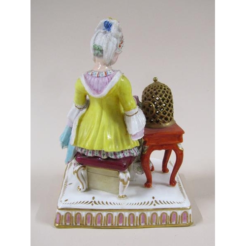 1967 - A pair of Meissen porcelain figure groups - girl seated feeding bird in cage & lady seated with dres... 