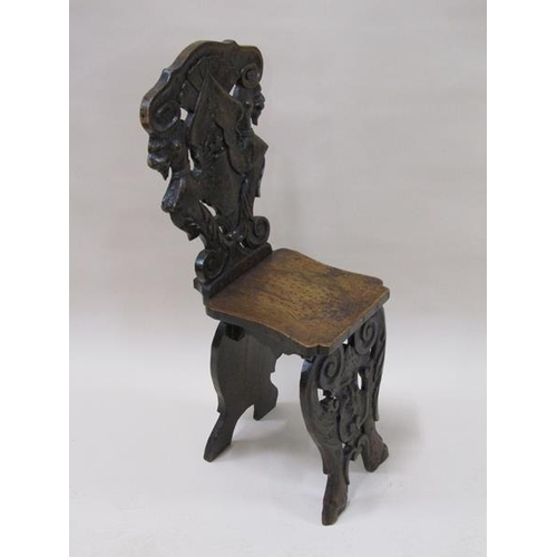 2020 - A 19c Italian Sgabello side chair, the back carved with winged lions with shaped seat and mask carve... 