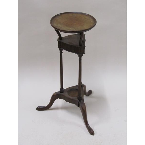 2021 - A late Georgian mahogany wash stand, the circular top supported on tripartite type columns on a base... 