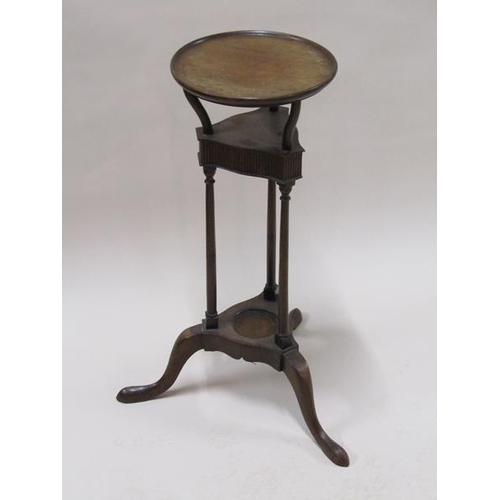 2021 - A late Georgian mahogany wash stand, the circular top supported on tripartite type columns on a base... 