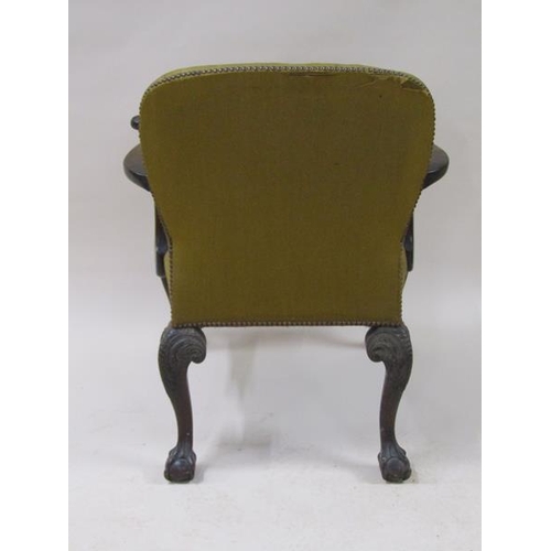 2039 - A mid Georgian style mahogany open armchair with scrolling arms, having leaf carved terminals with s... 