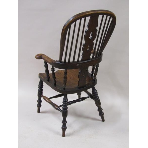 2040 - A Victorian Windsor ash and elm hoop spindle back armchair with bold turned and baluster carved legs... 