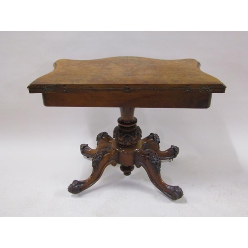 2042 - A mid Victorian burr walnut fold over serpentine card table with a scroll and floral carved frieze, ... 