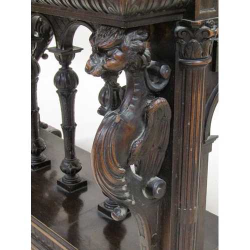 2067 - A 19c oak centre table of rectangular form, the table edge and frieze lunette carved and supported o... 