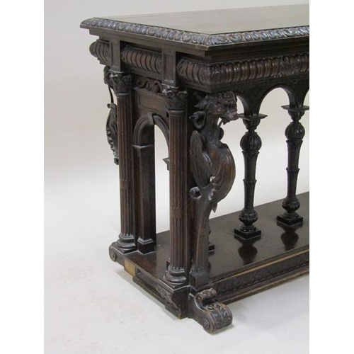 2067 - A 19c oak centre table of rectangular form, the table edge and frieze lunette carved and supported o... 