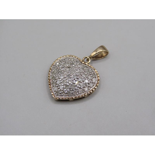 1613 - A 9ct gold pave set diamond heart shaped pendant with hanger.